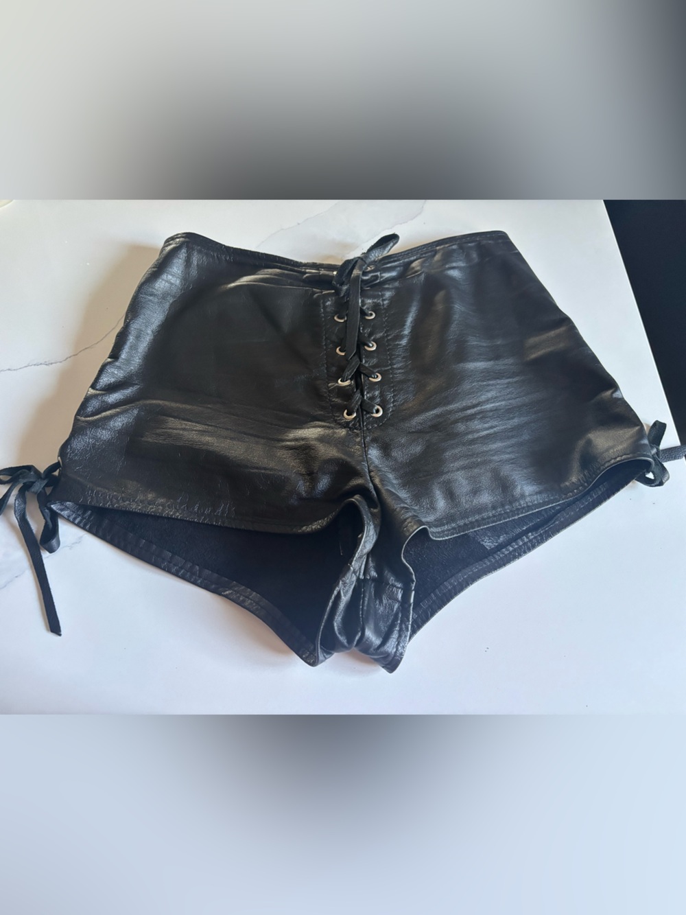 black leather lace-up micro shorts,